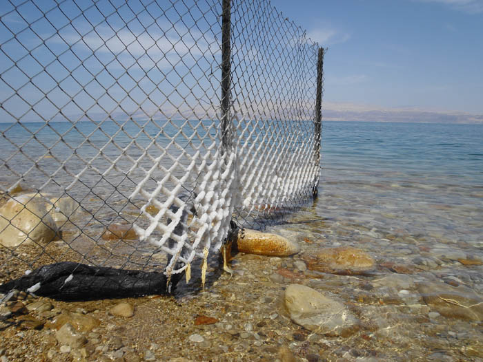 Salt covered fence at the Dead Sea
