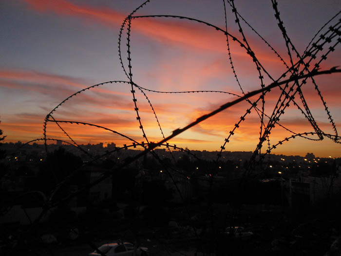 Sunset through barb wire in Jerusalem